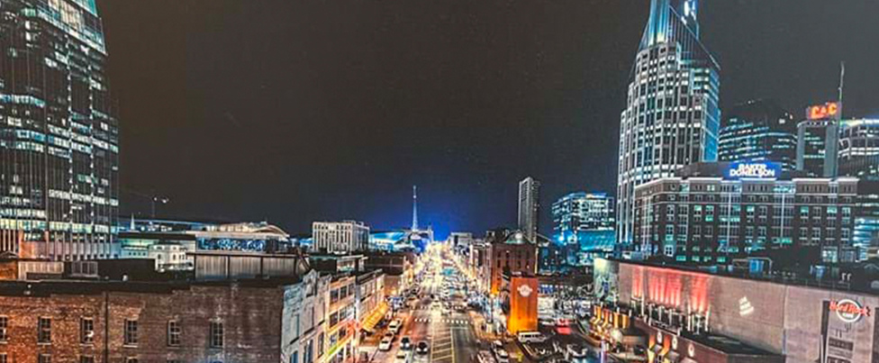 Nashville by night with illuminated buildings and streets.